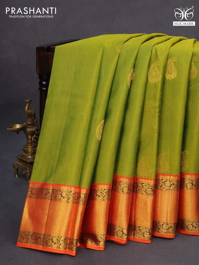 Pure kanchipuram silk saree light green and orange with paisley zari woven buttas and zari woven korvai border