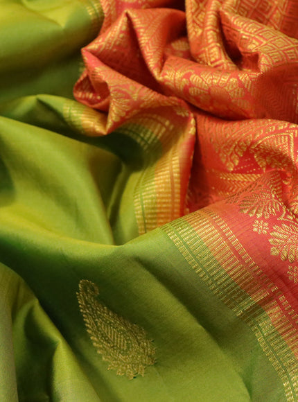 Pure kanchipuram silk saree light green and orange with paisley zari woven buttas and zari woven korvai border