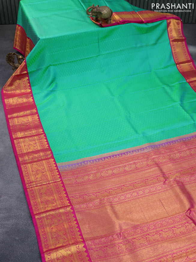 Pure kanchipuram silk saree dual shade of teal green and pink with allover self emboss and zari woven korvai border