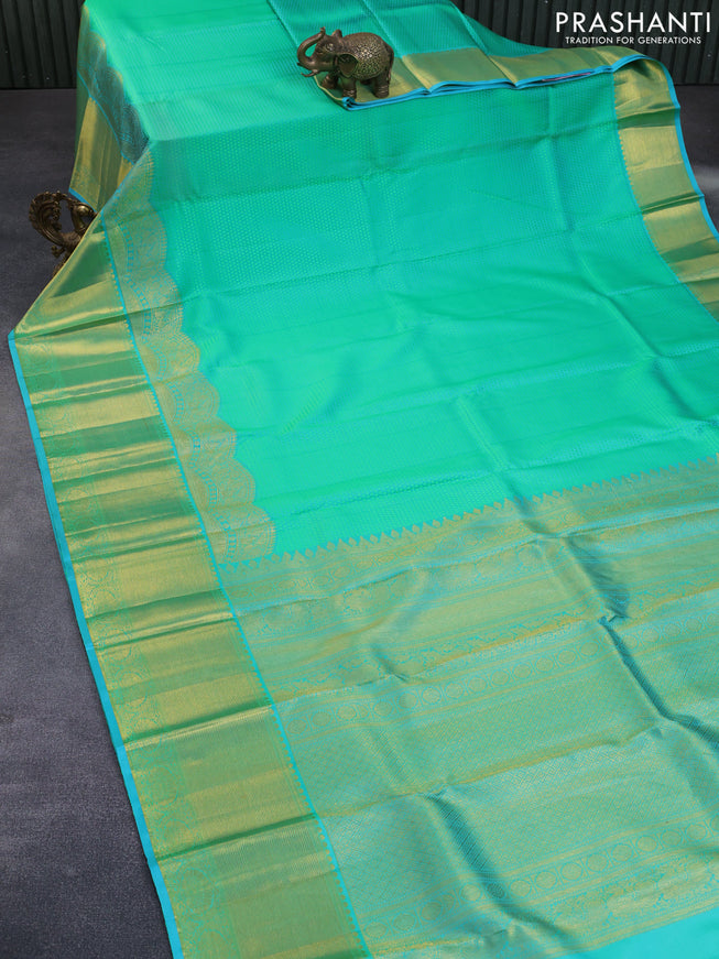 Pure kanchipuram silk saree dual shade of teal green and teal blue with allover self emboss and long zari woven border