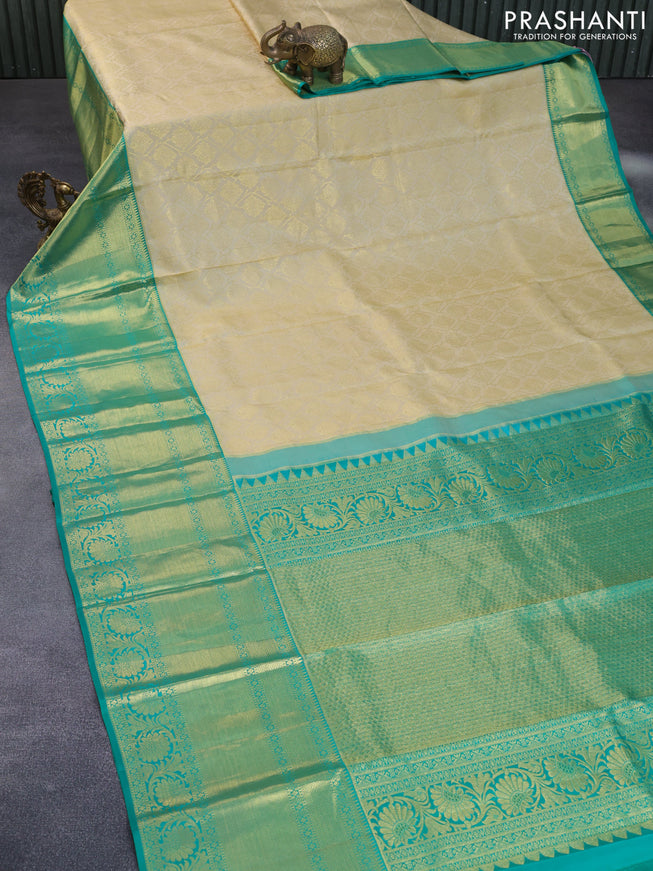 Pure kanchipuram silk saree cream and teal green with allover zari woven brocade weaves and zari woven floral border