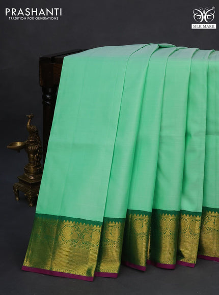 Pure kanchipuram silk saree pastel green and purple with plain body and zari woven korvai border