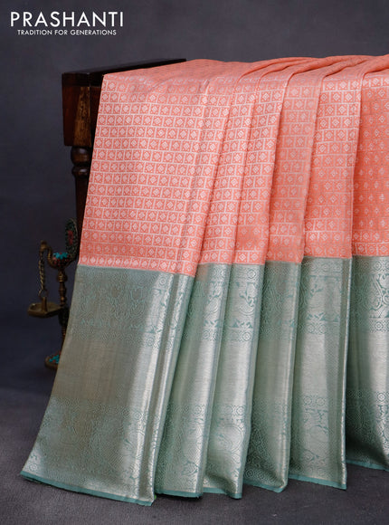 Pure kanchipuram silk saree peach shade and pastel green with allover silver zari woven brocade weaves and long silver zari woven border