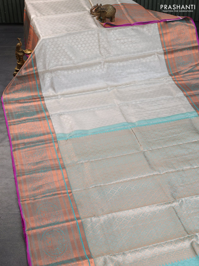 Pure kanchipuram tissue silk saree off white and dual shade of teal blue with allover silver zari woven brocade weaves and long copper zari woven border