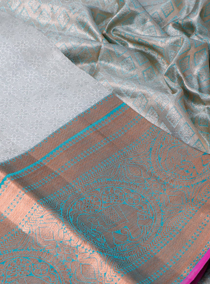 Pure kanchipuram tissue silk saree off white and dual shade of teal blue with allover silver zari woven brocade weaves and long copper zari woven border