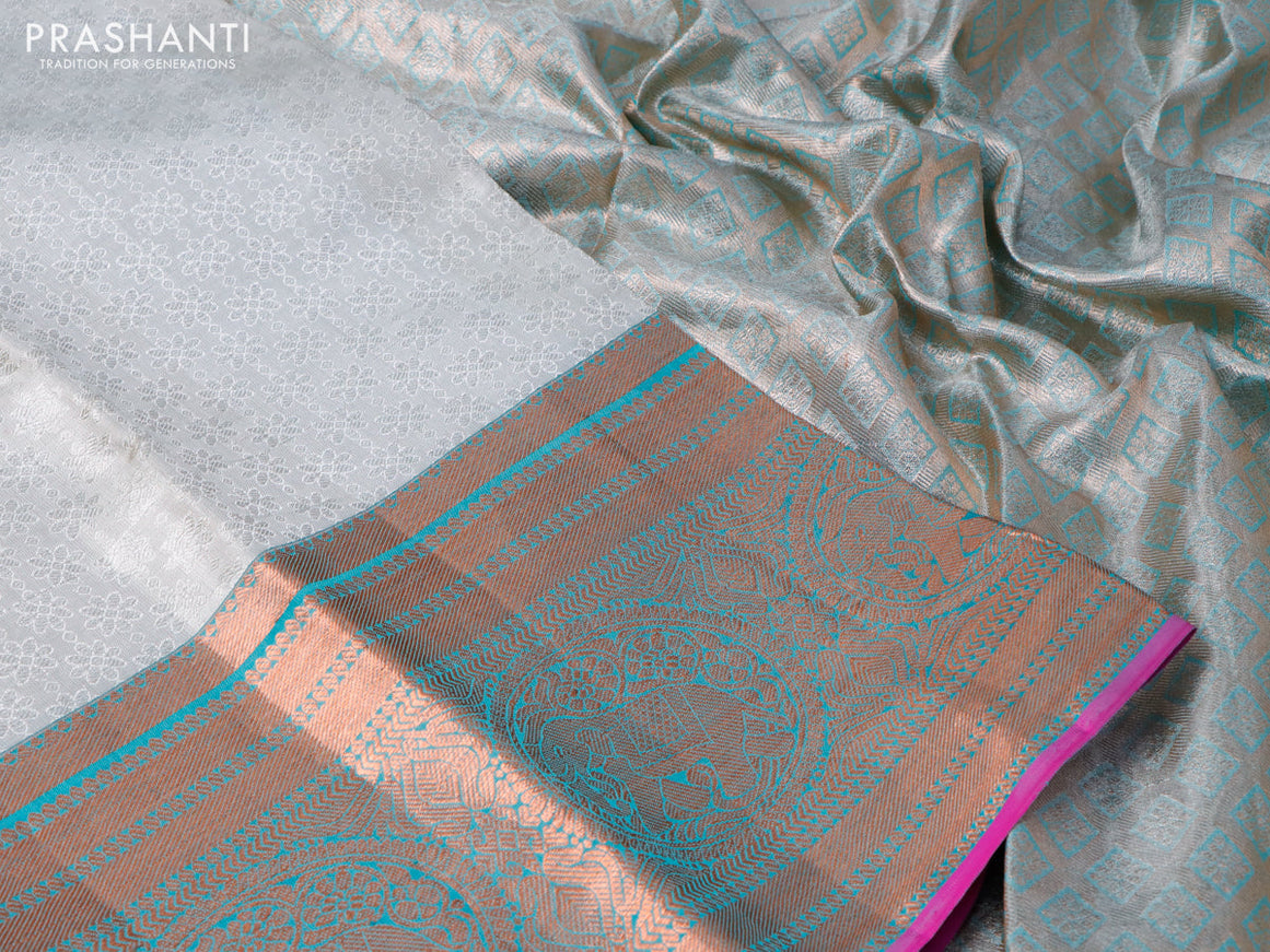 Pure kanchipuram tissue silk saree off white and dual shade of teal blue with allover silver zari woven brocade weaves and long copper zari woven border