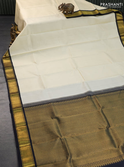 Pure kanchipuram silk saree cream and black with plain body and zari wove korvai border