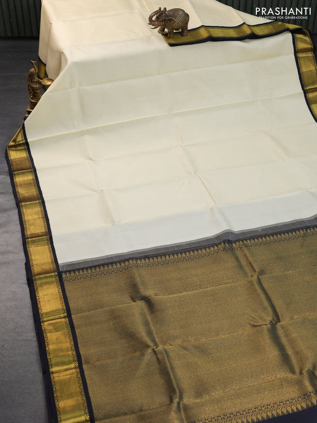 Pure kanchipuram silk saree cream and black with plain body and zari wove korvai border