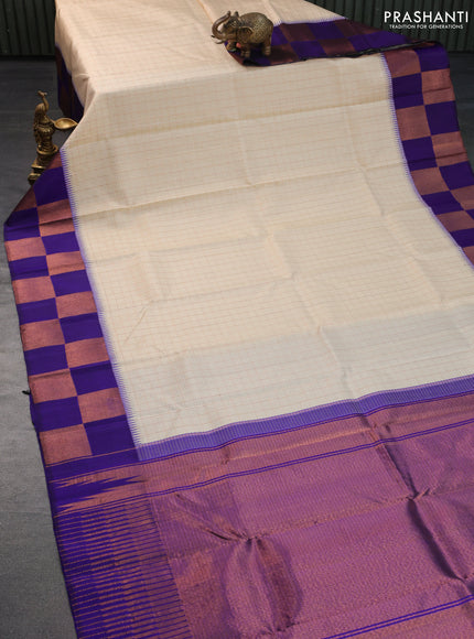 Pure kanchipuram silk saree cream and blue with allover copper zari checked pattern and temple design copper zari woven border