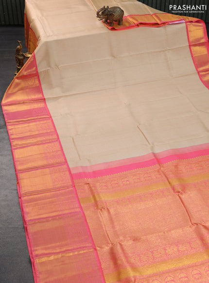 Pure kanchipuram silk saree cream and dual shade of peach orange with allover zari weaves and long zari woven border