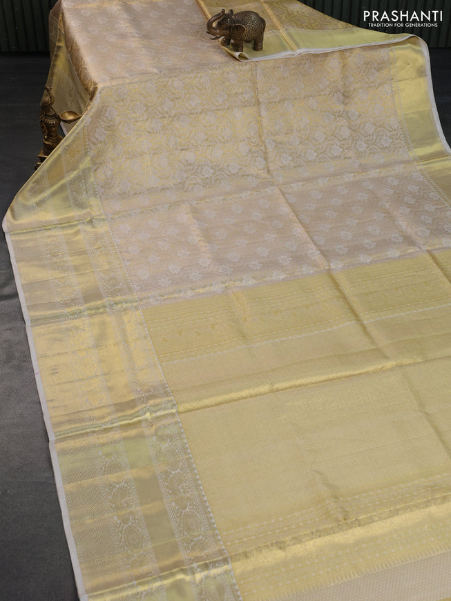 Pure kanchipuram tissue silk saree cream with allover zari woven brocade weaves and long rich zari woven border