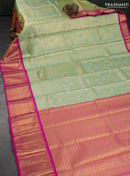 Pure kanchipuram silk saree dual shade of green and pink with allover zari woven floral brocade weaves and long zari woven korvai border