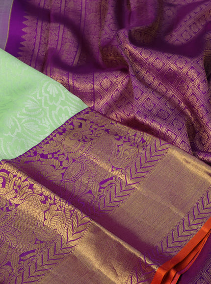 Pure kanchipuram silk saree pista green and violet with allover silver zari weaves and long annam zari woven korvai border