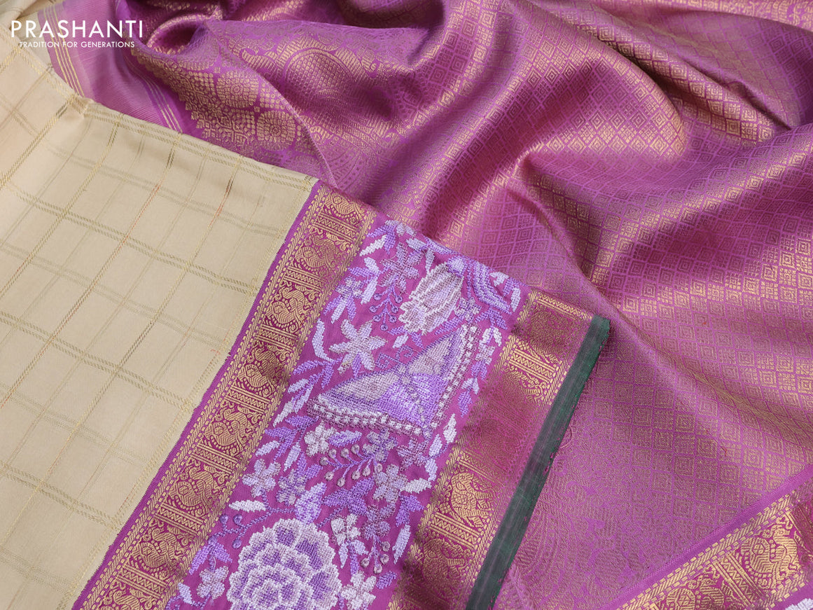 Pure kanchipuram silk saree cream and lavender shade with allover zari checked pattern and embroidery work zari border