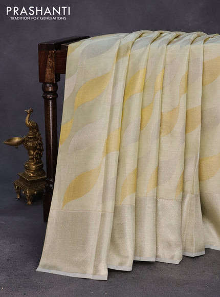 Pure kanchipuram tissue silk saree cream with allover zari weaves and silver zari woven border