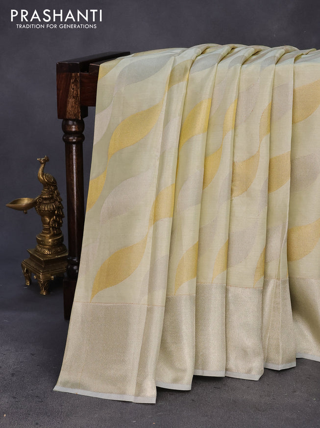 Pure kanchipuram tissue silk saree cream with allover zari weaves and silver zari woven border