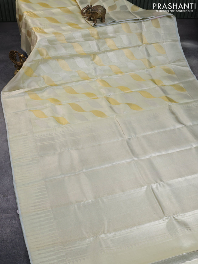 Pure kanchipuram tissue silk saree cream with allover zari weaves and silver zari woven border