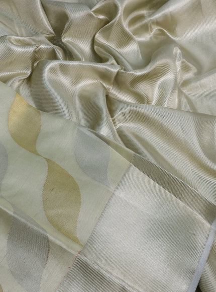 Pure kanchipuram tissue silk saree cream with allover zari weaves and silver zari woven border