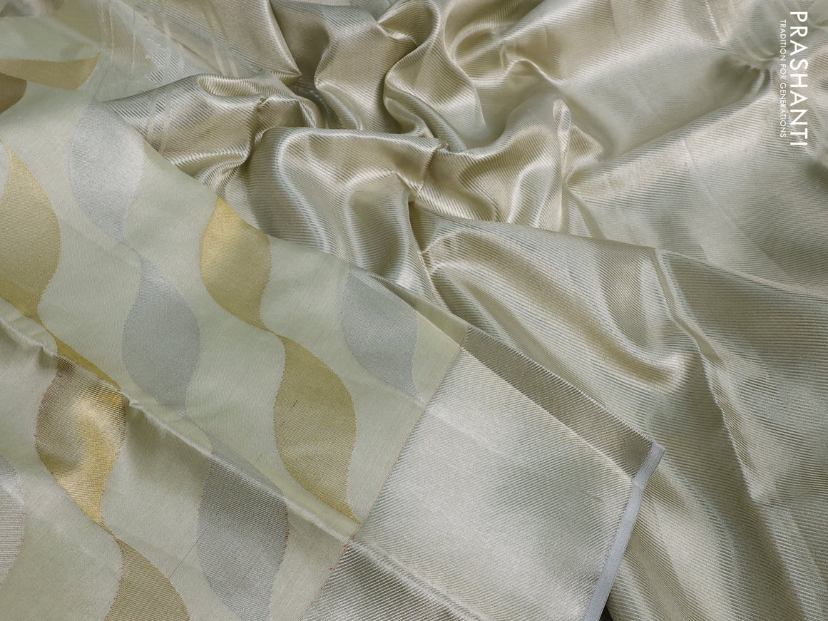 Pure kanchipuram tissue silk saree cream with allover zari weaves and silver zari woven border