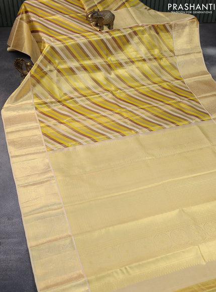 Pure kanchipuram tissue silk saree yellow and cream with allover stripes pattern and zari woven border