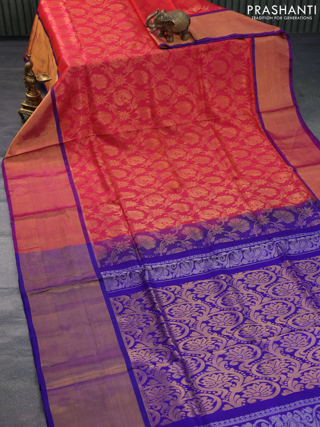 Pure uppada silk saree dual shade of pinkish orange and blue with allover zari woven brocade weaves and long zari woven border