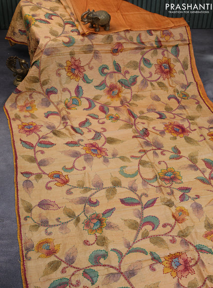 Pure tussar silk saree yellow shade and sandal with allover kalamkari prints & french knot work and piping border