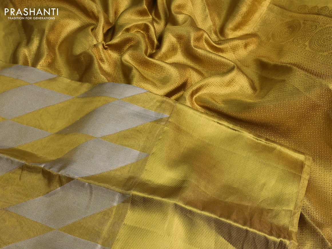 Pure kanchipuram tissue silk saree gold with allover zari woven geometric weaves and long zari woven border