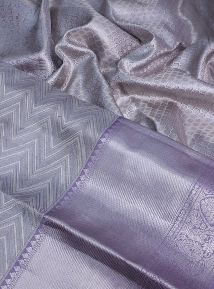 Pure kanchipuram tissue silk saree pastel grey and mild lavender shade with allover silver zari woven weaves and silver zari woven border