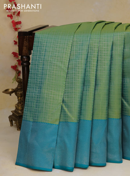 Pure kanchipuram silk saree dual shade of green and teal blue with allover silver zari woven checked pattern and silver zari woven border