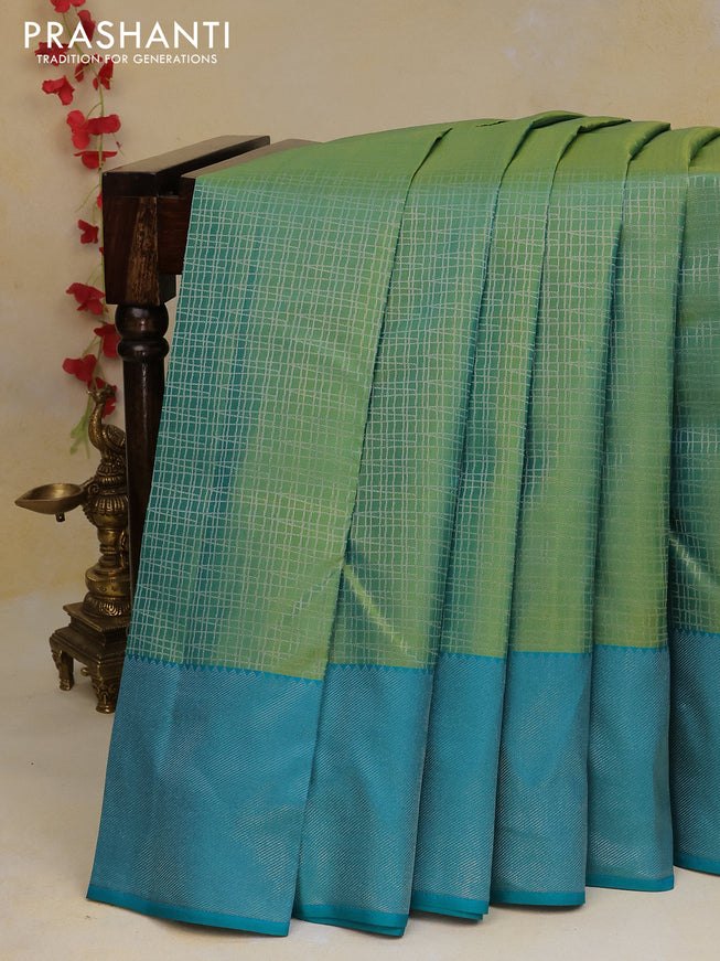 Pure kanchipuram silk saree dual shade of green and teal blue with allover silver zari woven checked pattern and silver zari woven border