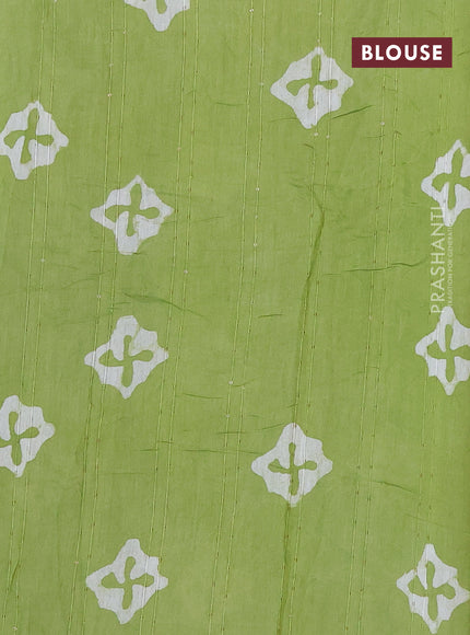 Batik cotton saree light green with allover sequin work & batik butta prints and printed lace work border