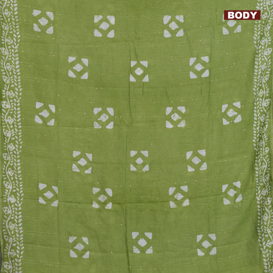 Batik cotton saree light green with allover sequin work & batik butta prints and printed lace work border