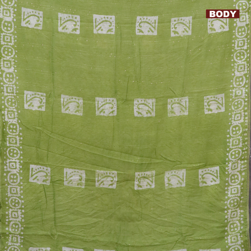 Batik cotton saree light green with allover sequin work & batik butta prints and printed lace work border