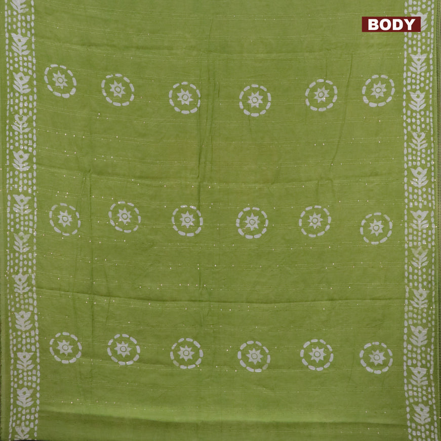 Batik cotton saree light green with allover sequin work & batik butta prints and printed lace work border