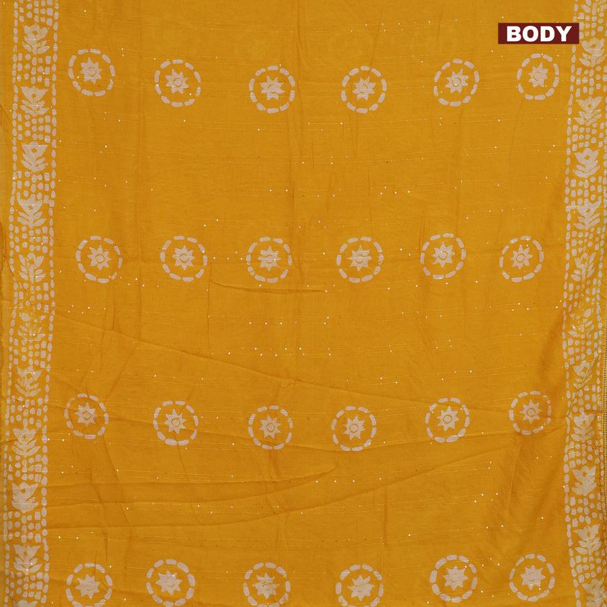 Batik cotton saree mustard yellow with allover sequin work & batik butta prints and printed lace work border