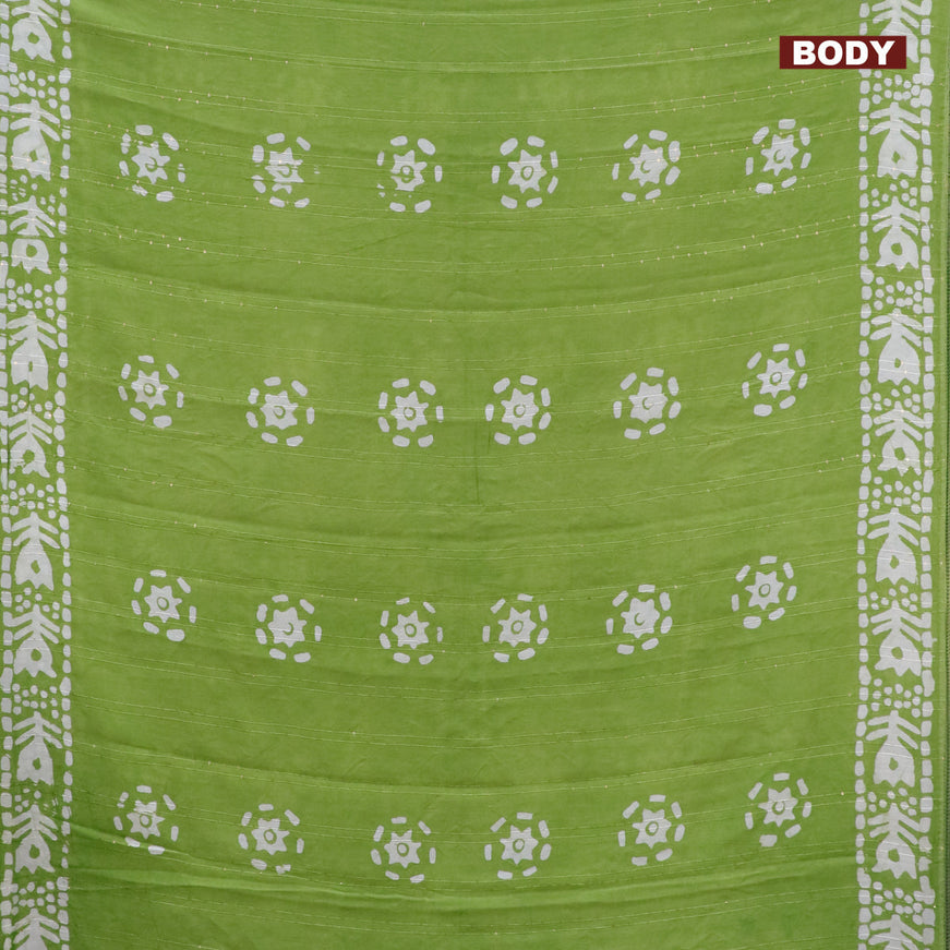 Batik cotton saree light green with allover sequin work & batik butta prints and printed lace work border