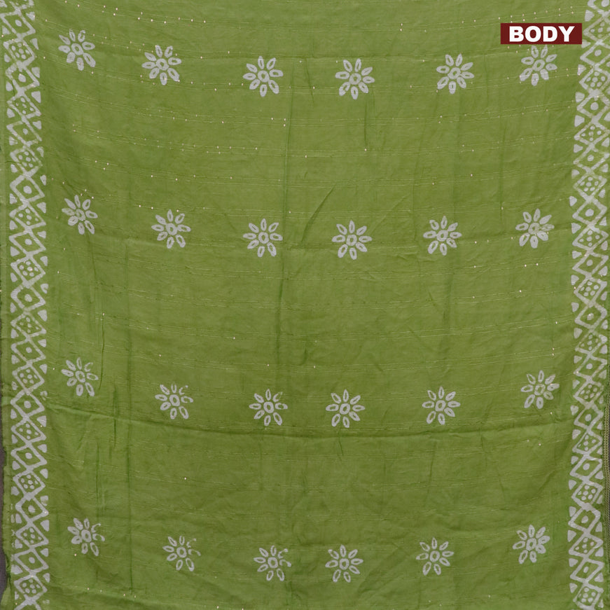 Batik cotton saree light green with allover sequin work & batik butta prints and printed lace work border