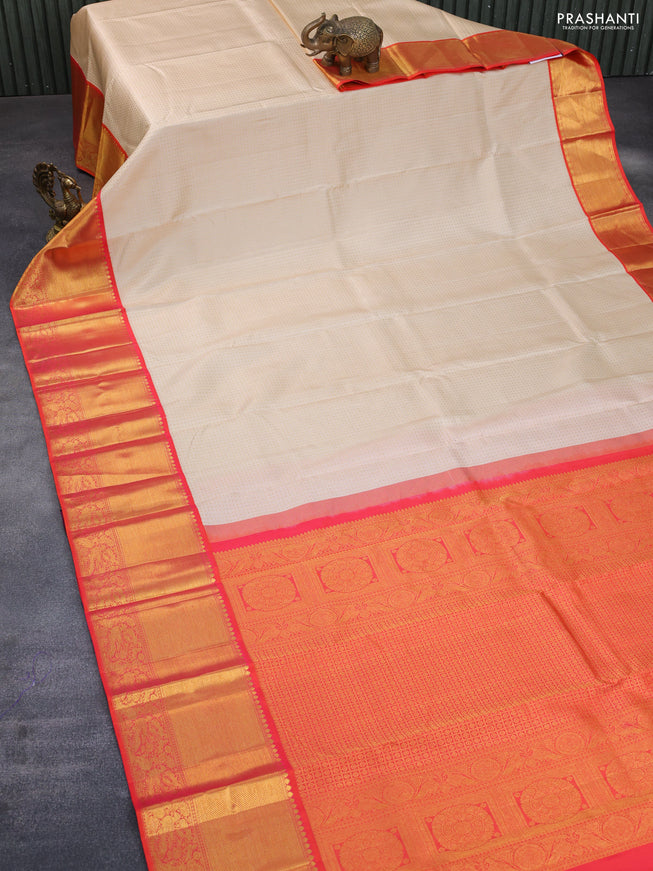 Pure kanchipuram silk saree cream and orange with allover zari woven butta weaves and long rich zari woven korvai border