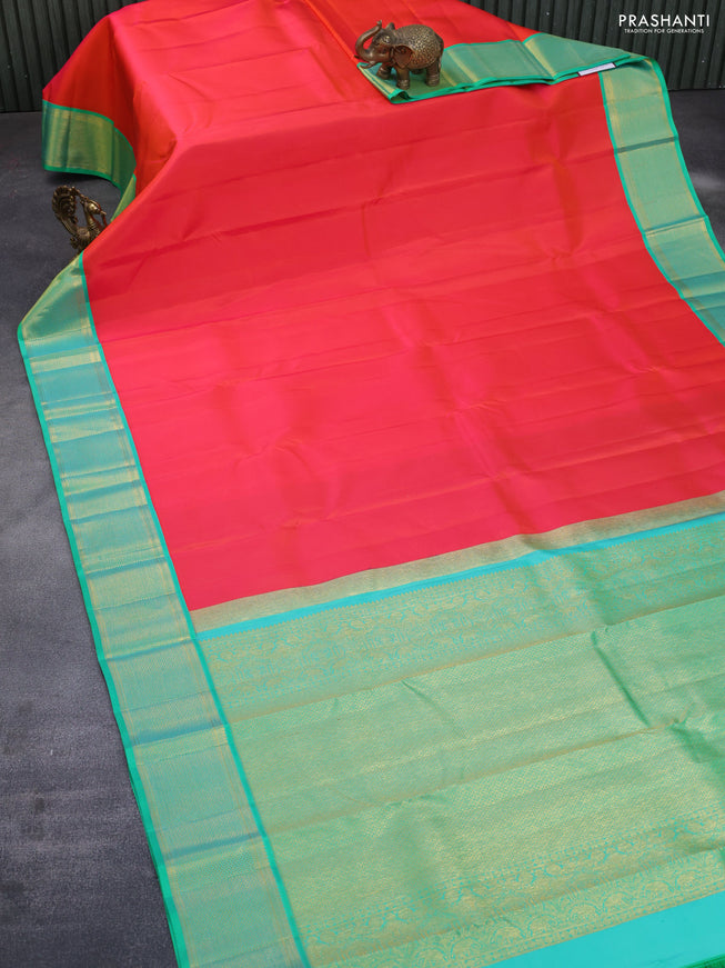 Pure kanchipuram silk saree dual shade of orange and green with plain body and zari woven border