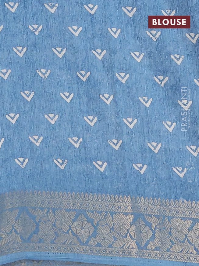 Semi dola saree blue shade with allover floral prints & self emboss and zari woven border