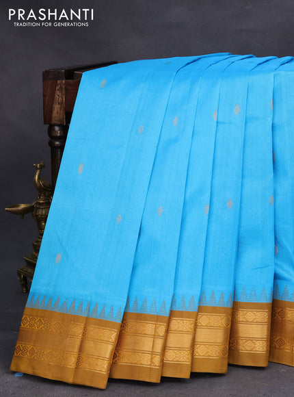 Silk cotton saree light blue and mustard shade with zari woven buttas and temple design zari woven korvai border