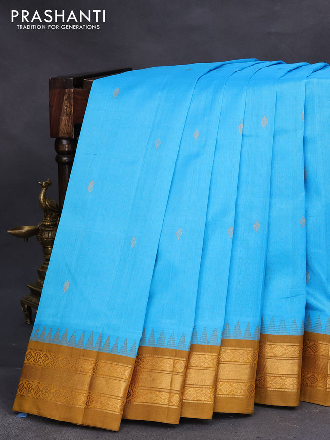 Silk cotton saree light blue and mustard shade with zari woven buttas and temple design zari woven korvai border