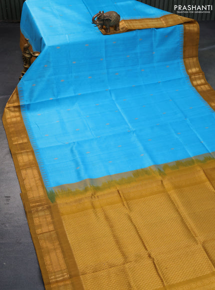 Silk cotton saree light blue and mustard shade with zari woven buttas and temple design zari woven korvai border