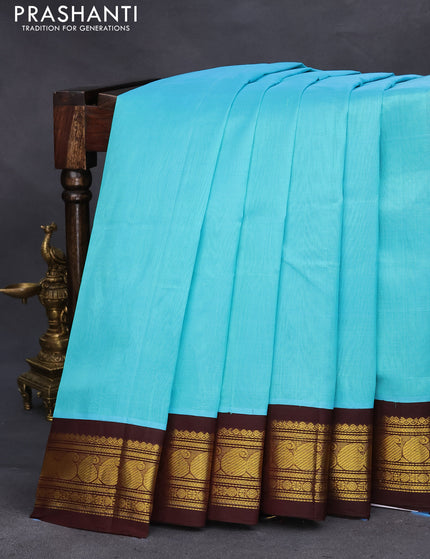 Silk cotton saree teal blue and coffee brown with plain body and zari woven korvai border