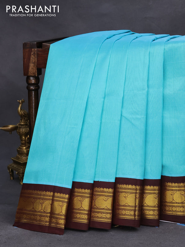 Silk cotton saree teal blue and coffee brown with plain body and zari woven korvai border