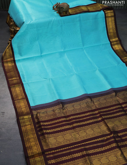 Silk cotton saree teal blue and coffee brown with plain body and zari woven korvai border