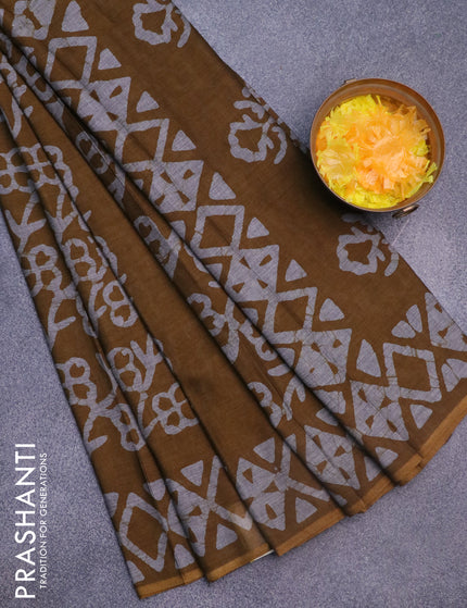 Muslin cotton saree dark mustard with allover batik prints and printed border