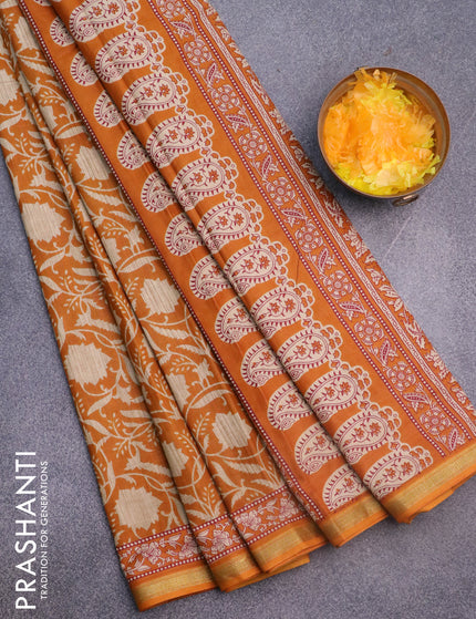 Muslin cotton saree dark mustard with allover floral prints and small zari woven border