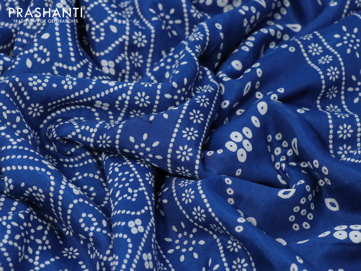 Semi crepe saree peacock blue with allover bandhani prints and zari woven border