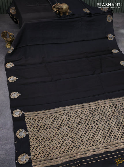 Mushru silk saree black with allover self emboss and zari woven butta border